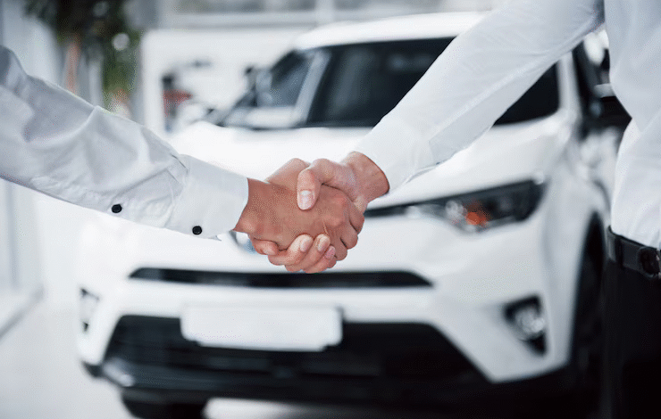 Car owner selling used car to buyer, illustrating how to sell used car effectively.